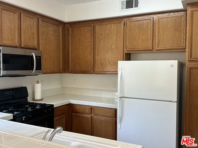 a kitchen with a refrigerator and cabinets