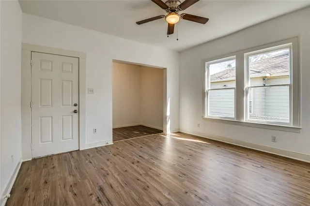 wooden floor in an empty room with a window