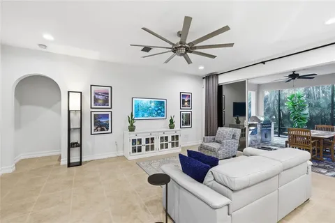 a kitchen with stainless steel appliances granite countertop a sink a stove and chairs