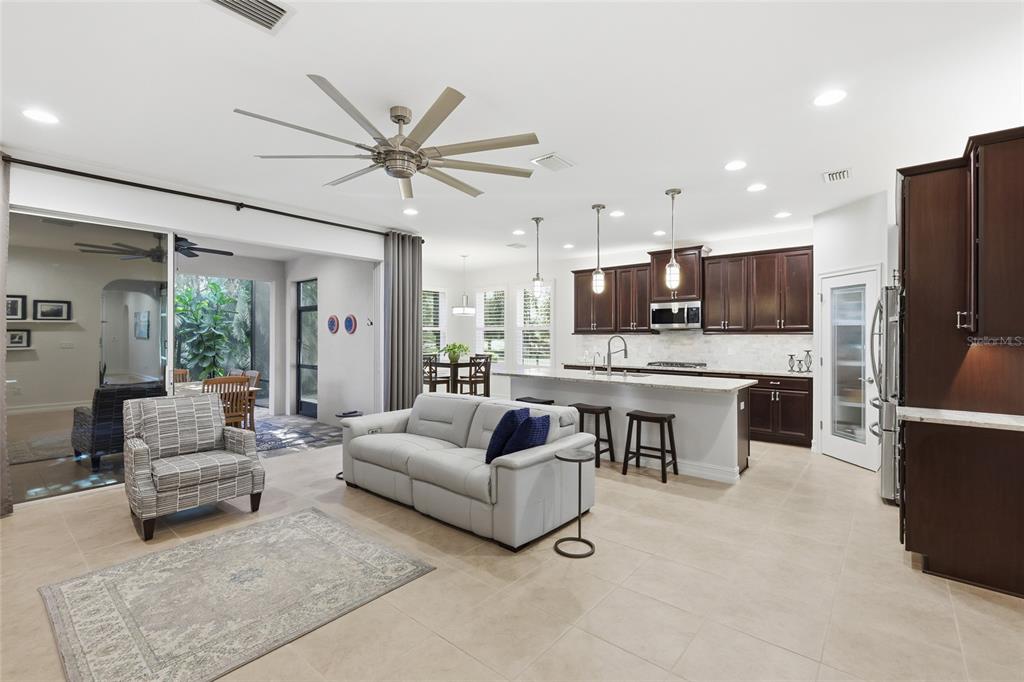 12106 Perennial Place Lakewood Ranch, FL 34211 - Photo 13 of 66 a living room with furniture and kitchen view
