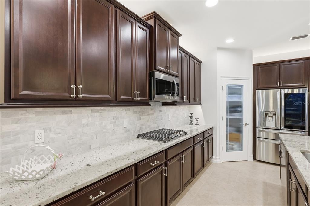 12106 Perennial Place Lakewood Ranch, FL 34211 - Photo 15 of 66 a kitchen with stainless steel appliances granite countertop a sink stove and refrigerator
