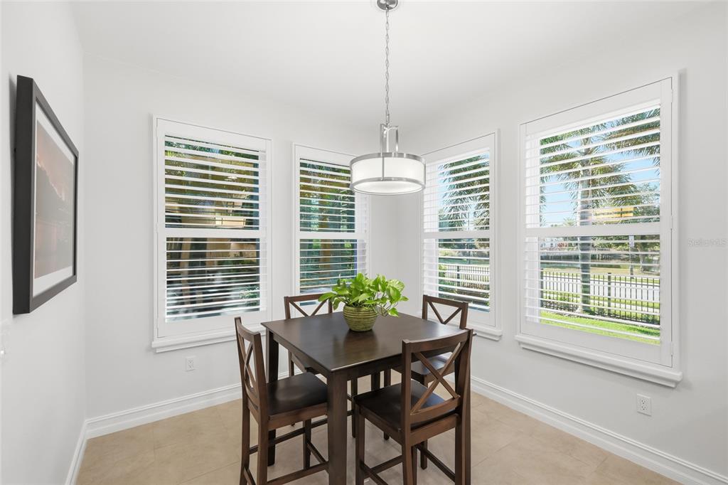 12106 Perennial Place Lakewood Ranch, FL 34211 - Photo 17 of 66 a view of a dining room with furniture window and outside view