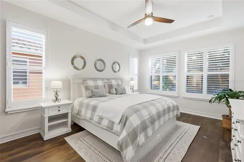 a bathroom with a granite countertop bathtub sink double and mirror