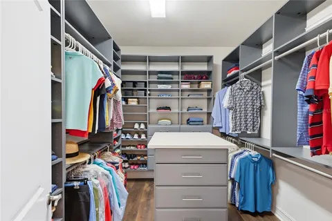 a bathroom with a granite countertop sink a toilet a mirror and shower