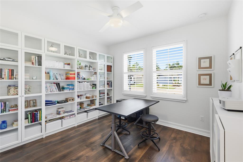 12106 Perennial Place Lakewood Ranch, FL 34211 - Photo 29 of 66 a view of a workspace with furniture and a bookshelf