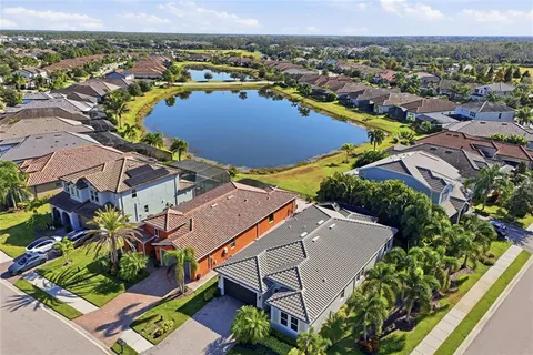 a living room with patio furniture and wooden floor