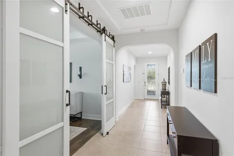 a living room with furniture a flat screen tv and a large window