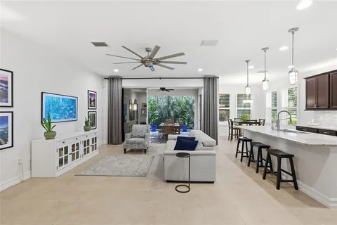 a living room with furniture and kitchen view