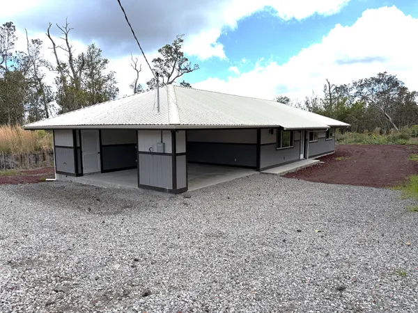 a wooden house with a yard and seating space