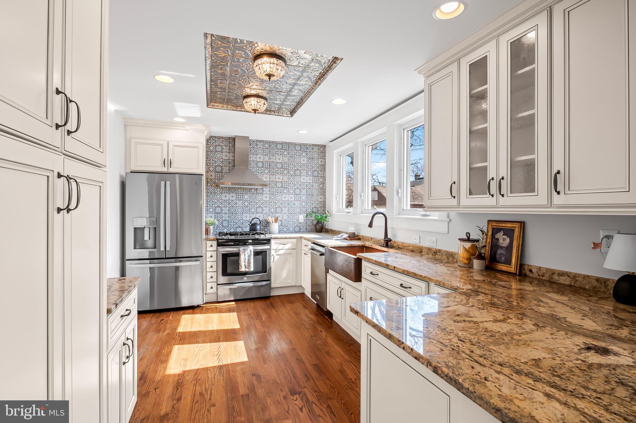 703 Chumleigh Road Baltimore, MD 21212 - Photo 13 of 41 a kitchen with stainless steel appliances granite countertop a stove and a sink