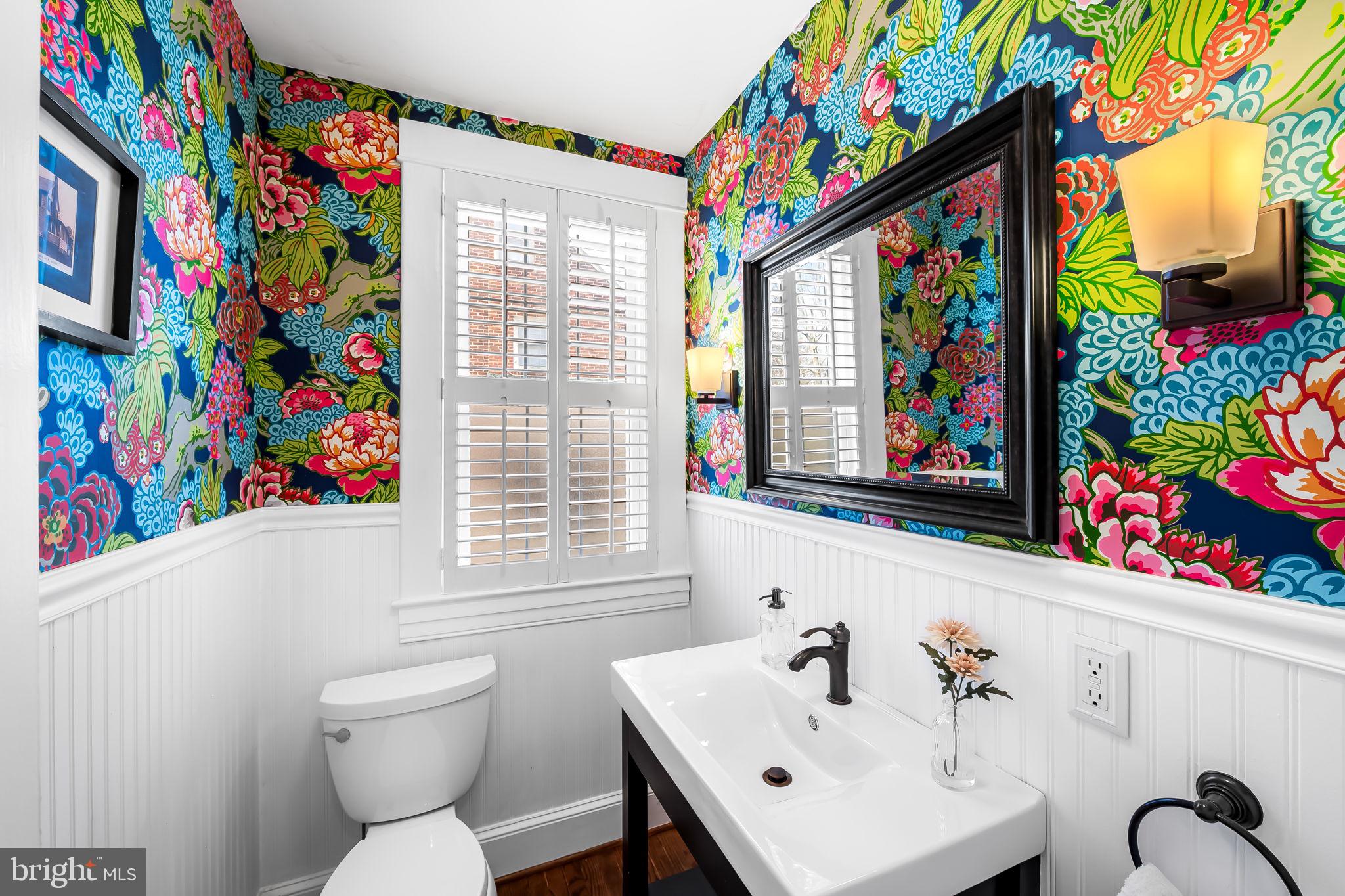 703 Chumleigh Road Baltimore, MD 21212 - Photo 18 of 41 a bathroom with a sink a toilet and a shower curtain