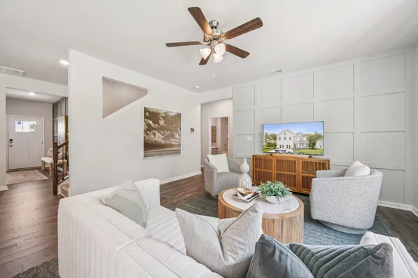 a living room with furniture and a wooden floor