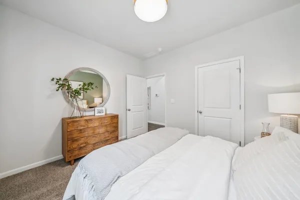 a bedroom with a bed and dresser