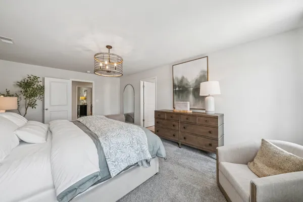 a bed room with a bed and a chandelier