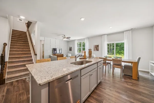 a kitchen with sink and view of living room