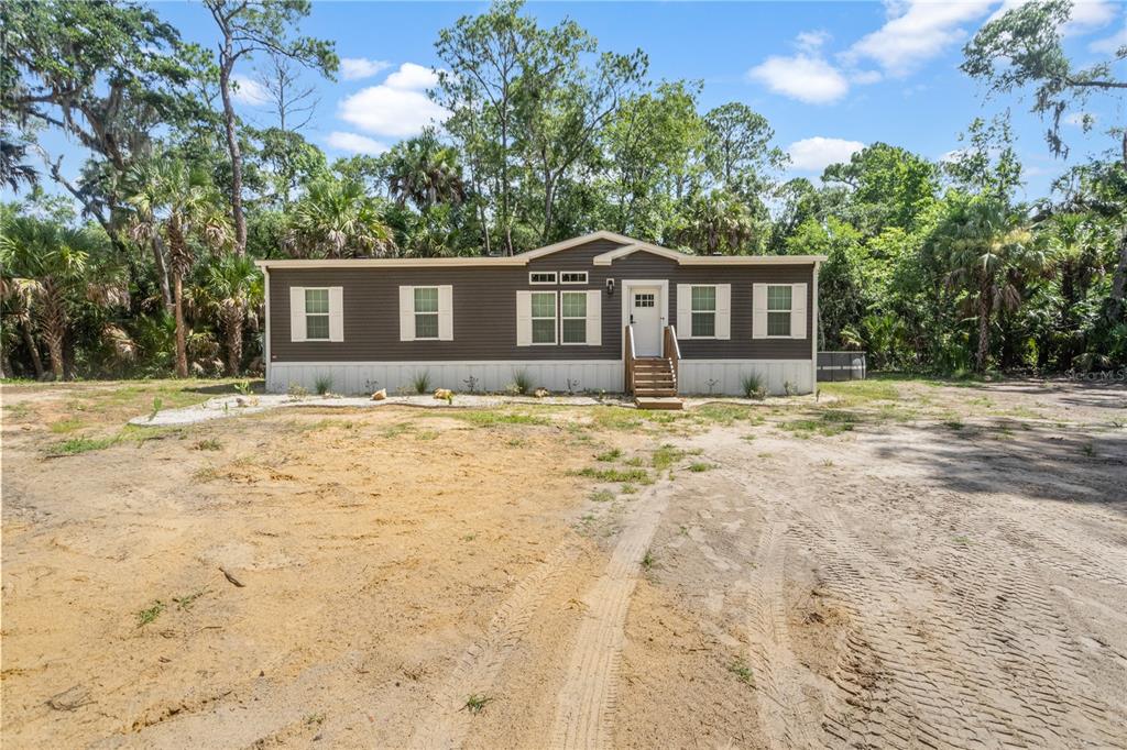 375 Sapp Street Inglis, FL 34449 - Photo 2 of 36 a house with trees in the background