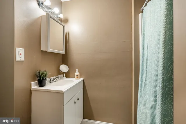 a bathroom with a sink vanity and a mirror