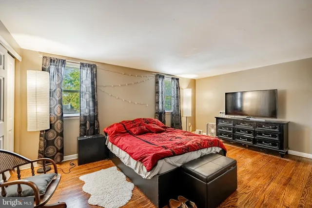 a bedroom with furniture and a flat screen tv