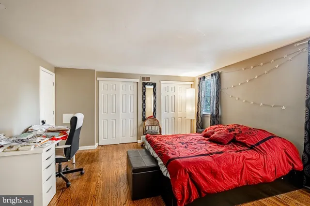 a bedroom with a bed and a desk