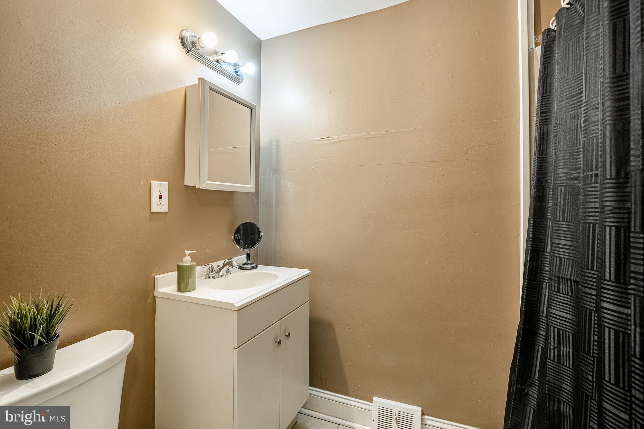 1607 Powell Road Brookhaven, PA 19015 - Photo 16 of 31 a bathroom with a sink a toilet and a mirror