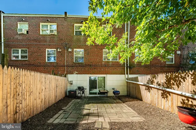 a view of a brick house with a small yard