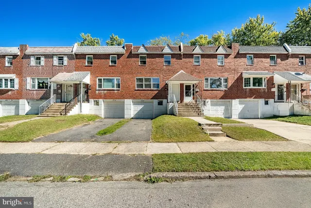 a front view of a residential apartment building with a yard
