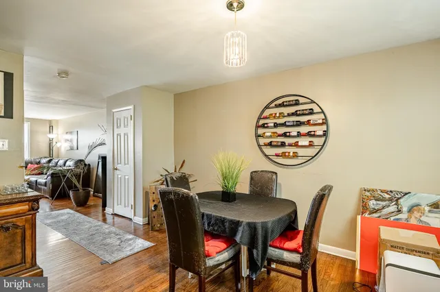 a view of a dining room with furniture and a chandelier