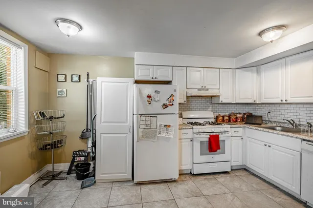 a kitchen with cabinets and white appliances
