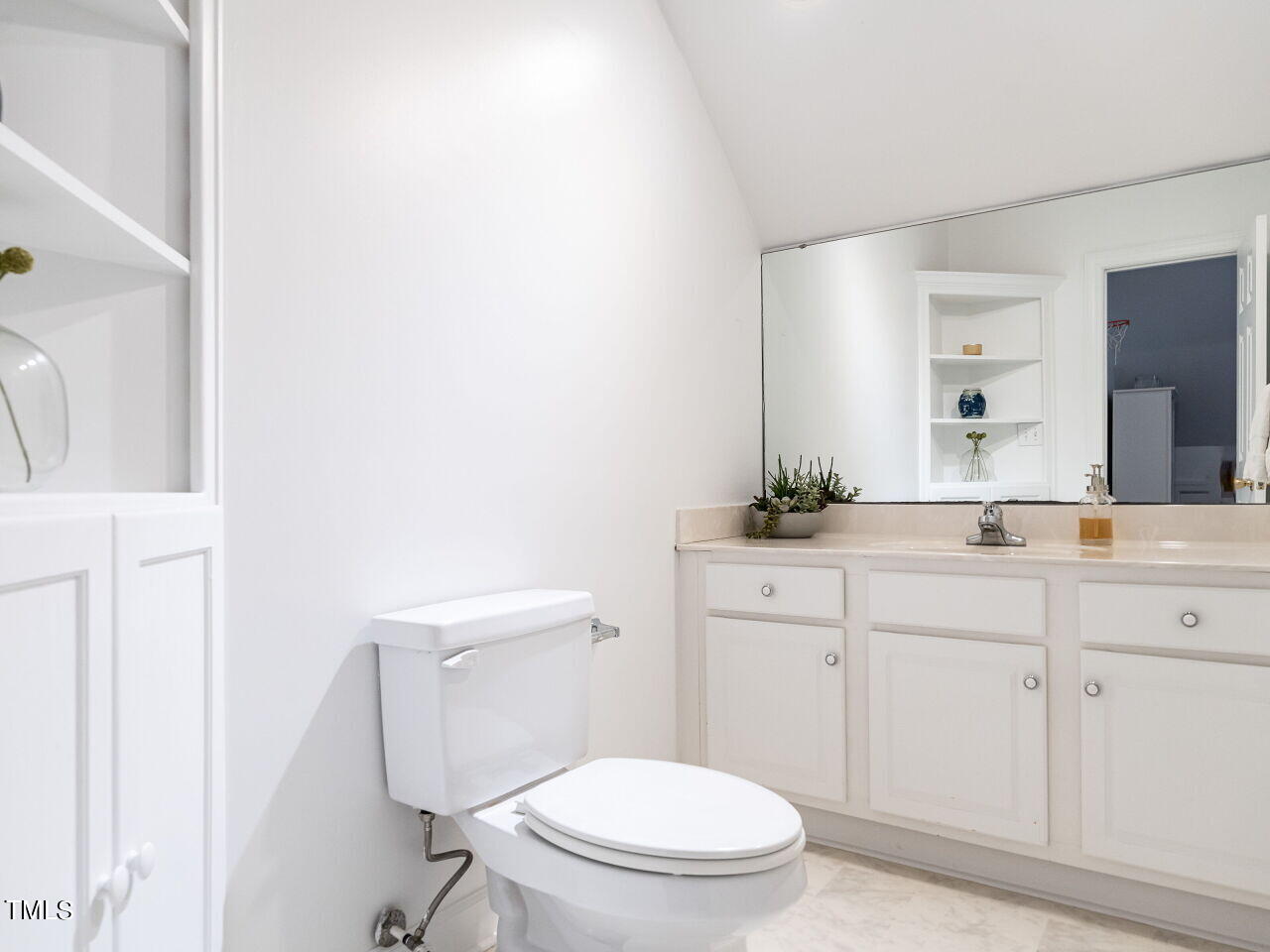 2100 Fallon Oaks Court Raleigh, NC 27608 - Photo 16 of 20 a bathroom with a sink a toilet a mirror and vanity