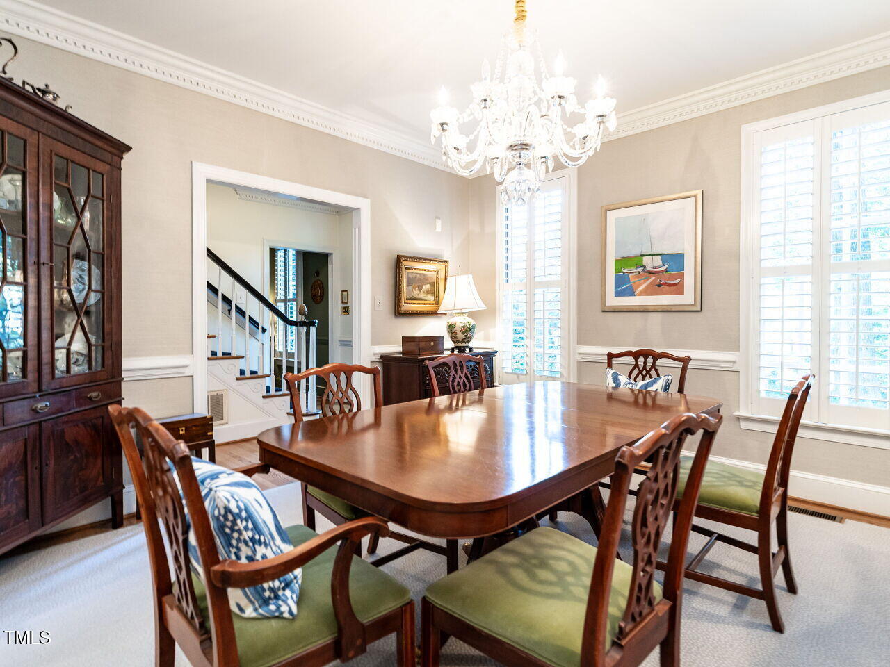2100 Fallon Oaks Court Raleigh, NC 27608 - Photo 3 of 20 a dining room with wooden floor a chandelier a wooden table and chairs