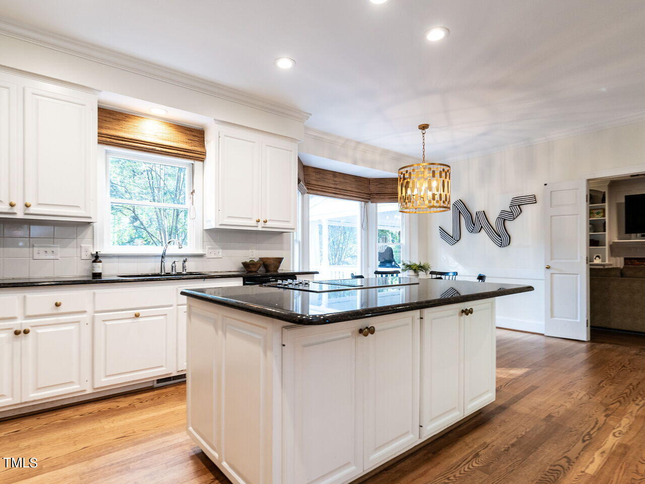 2100 Fallon Oaks Court Raleigh, NC 27608 - Photo 5 of 20 a kitchen with kitchen island granite countertop a sink a counter space appliances and cabinets