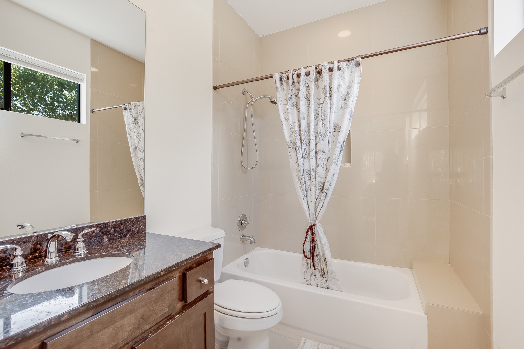 2205 Bastrop Street Houston, TX 77003 - Photo 22 of 31 a bathroom with a granite countertop sink a toilet and a bathtub