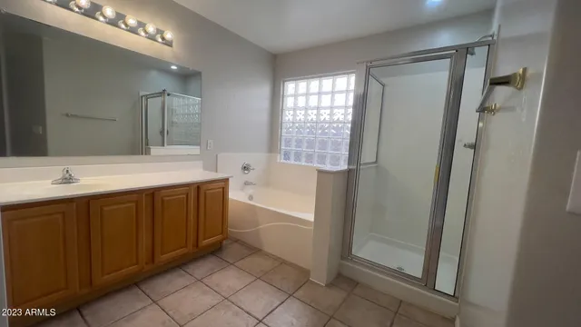 a bathroom with a double vanity sink toilet mirror and bathtub