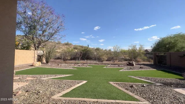 a view of a garden with a house