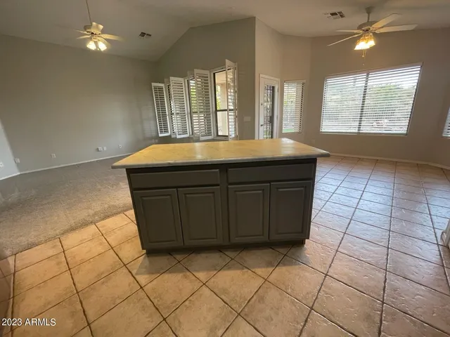 a kitchen with a sink a window and cabinets