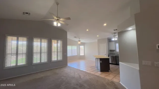 a view of an empty room with a kitchen