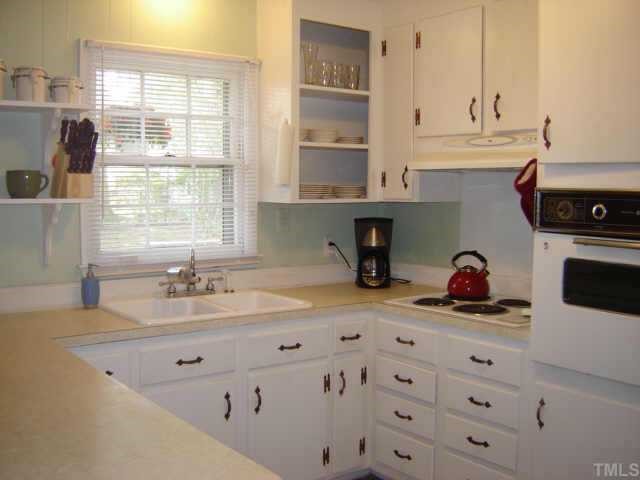 3201 Fairforest Place Raleigh, NC 27604 - Photo 3 of 10 a kitchen with a sink cabinets and window