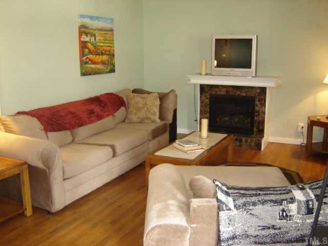 3201 Fairforest Place Raleigh, NC 27604 - Photo 5 of 10 a living room with furniture and a flat screen tv