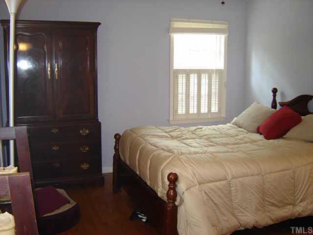 3201 Fairforest Place Raleigh, NC 27604 - Photo 6 of 10 a bedroom with a bed and a mirror