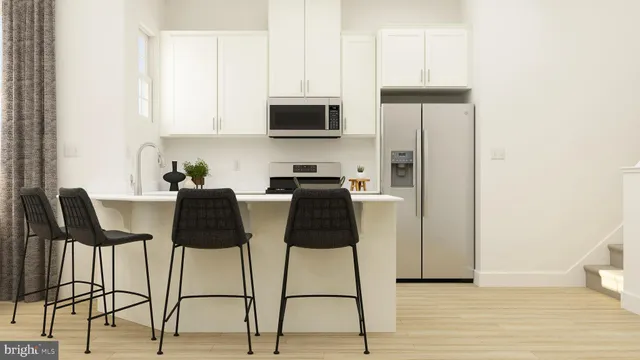 a kitchen with a table chairs refrigerator and microwave