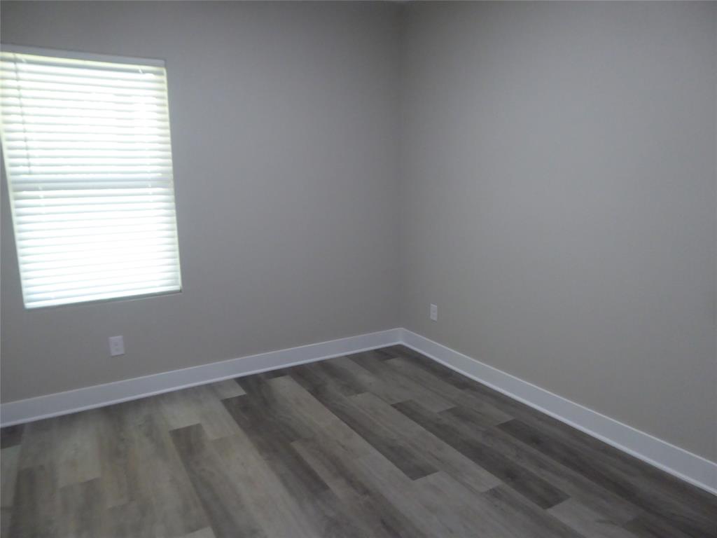230 Third Street Wilmer, TX 75172 - Photo 18 of 40 an empty room with a window