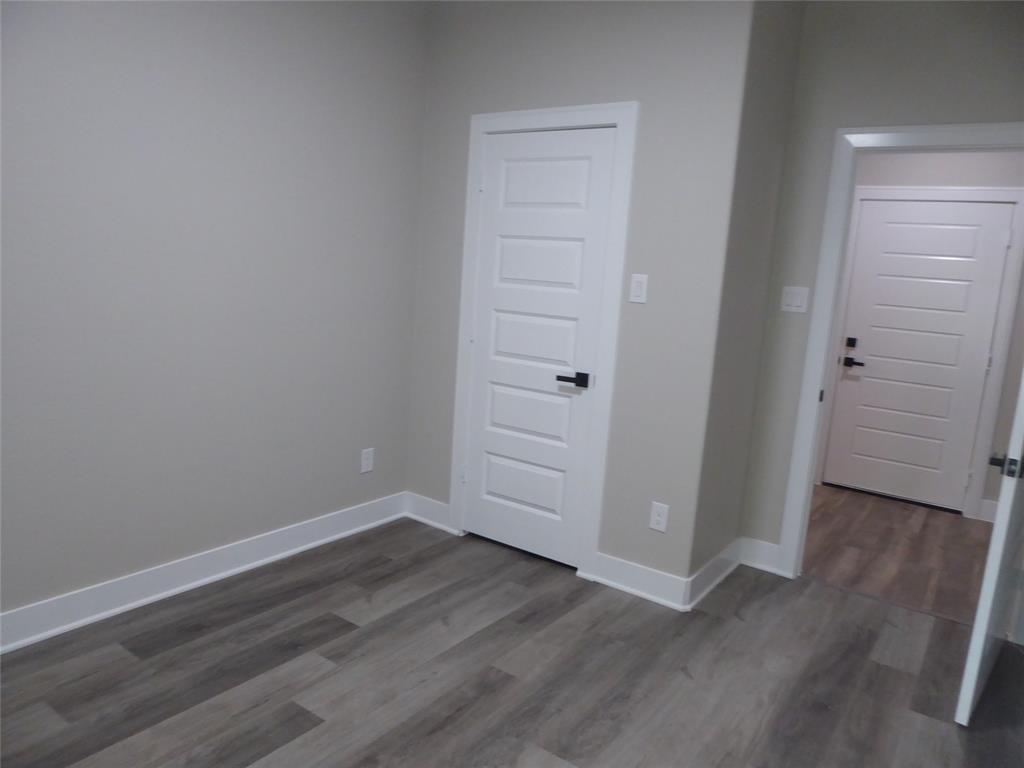 230 Third Street Wilmer, TX 75172 - Photo 19 of 40 an empty room with wooden floor