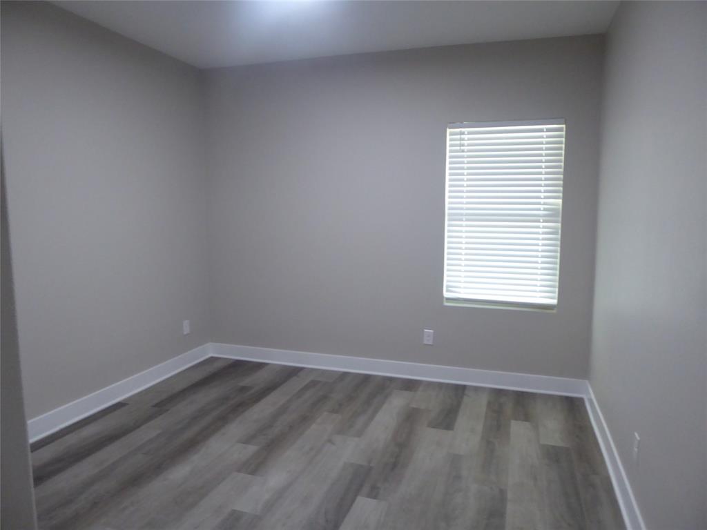 230 Third Street Wilmer, TX 75172 - Photo 20 of 40 wooden floor in an empty room with a window