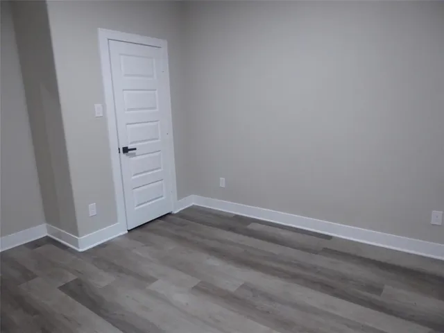 an empty room with wooden floor