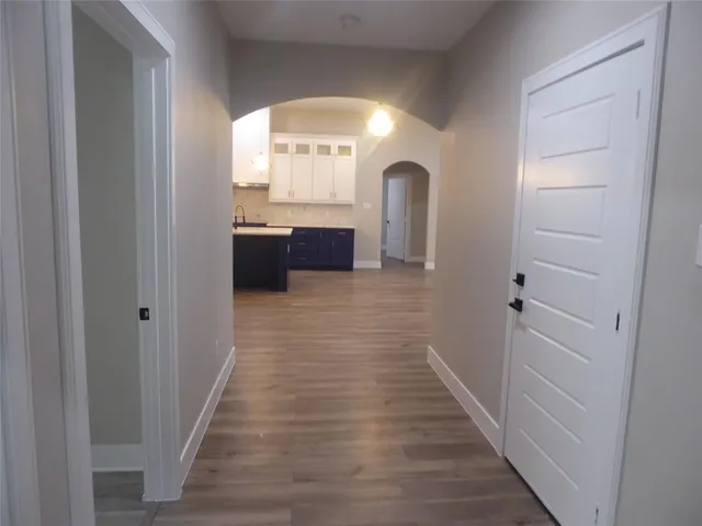 a view of a hallway view with wooden floor and staircase
