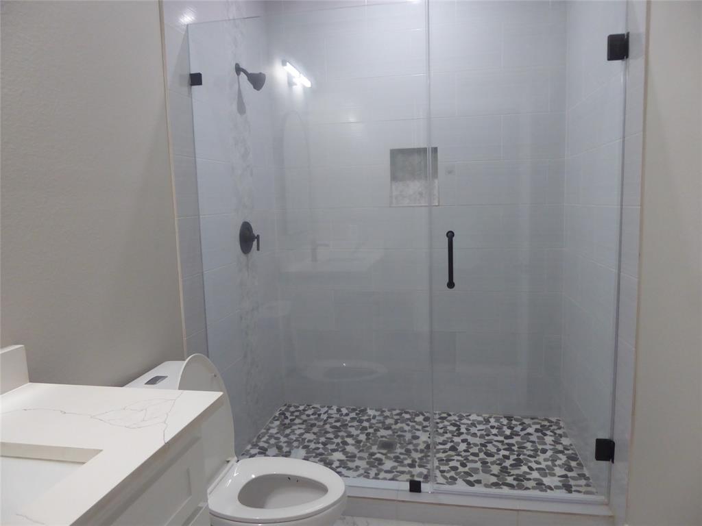 230 Third Street Wilmer, TX 75172 - Photo 40 of 40 a bathroom with a sink and a toilet