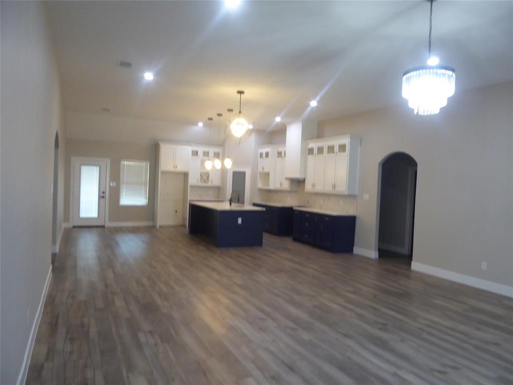 230 Third Street Wilmer, TX 75172 - Photo 8 of 40 a view of kitchen and hall with wooden floor and windows