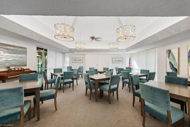 a view of a dining room with furniture and chandelier