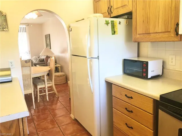 a kitchen with a refrigerator and cabinets
