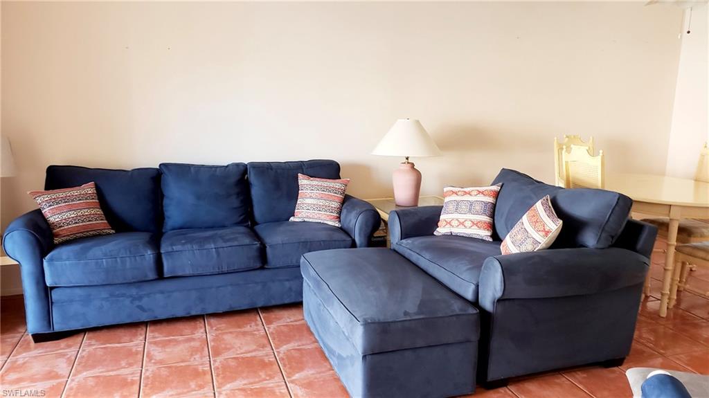 170 Turtle Lake Court, Unit 101 Naples, FL 34105 - Photo 7 of 16 a living room with furniture and a couch
